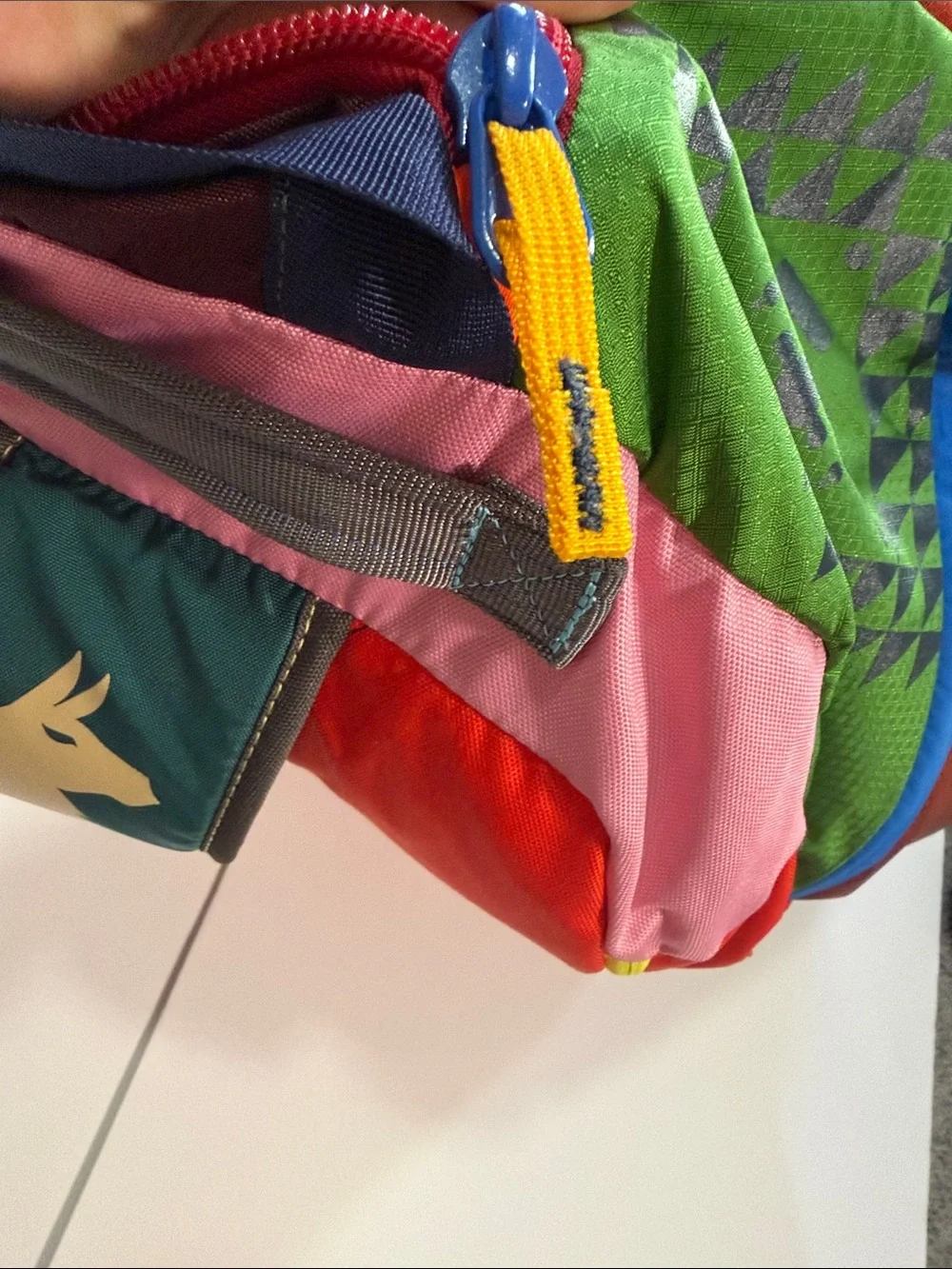 cotopaxi Green Duffel with Orange Logo and Multicolor Panels